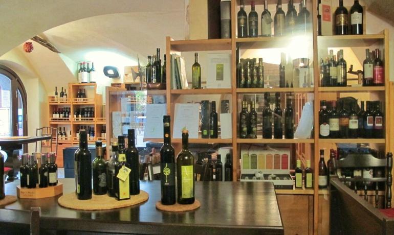 Wine shop with shelves of wines and oils displayed.