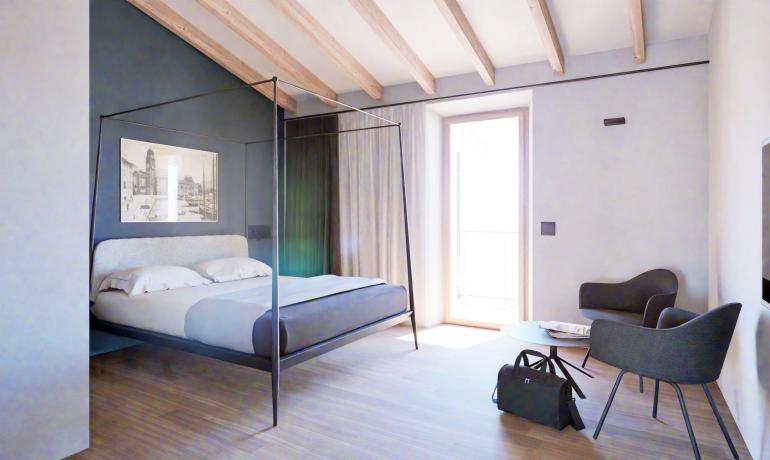 Modern room with canopy bed and stylish furnishings.