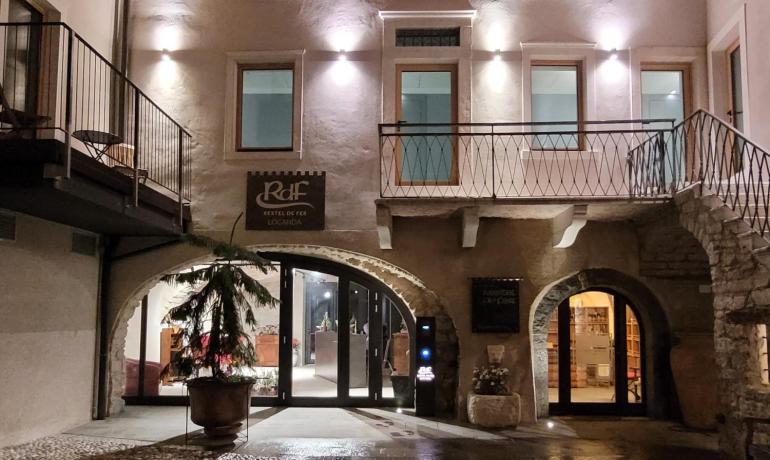 Cozy inn entrance, soft lights, rustic atmosphere.
