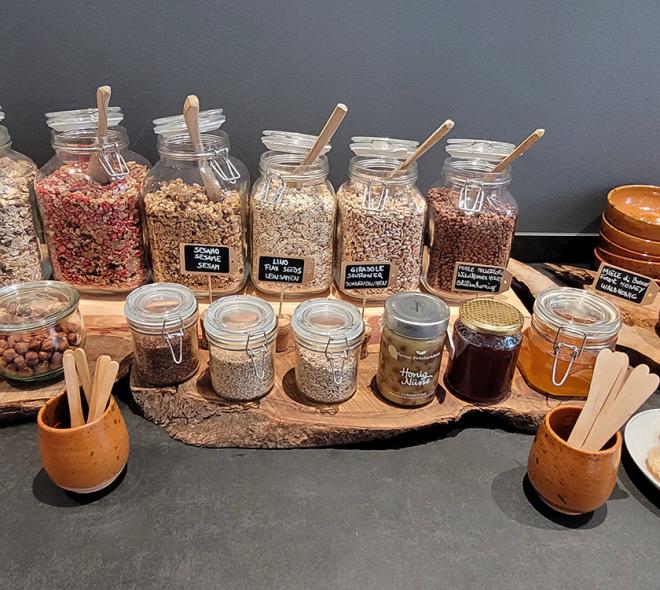 A rustic and inviting cereal and honey buffet.