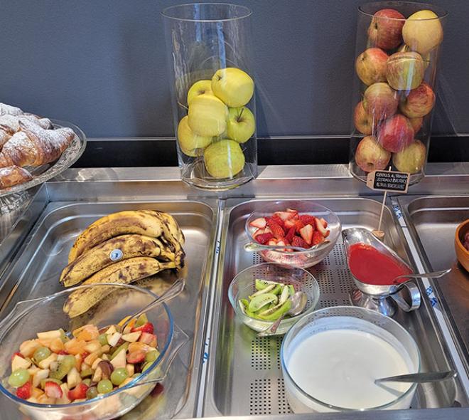 Vibrant buffet with fresh fruit, yogurt, and tempting croissants.
